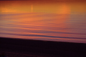 A beautiful spring sunset over the Baltic Sea with colorful skies and calm water. Natural evening scenery of Northern Europe