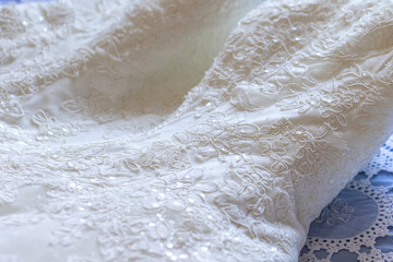 intricate lace detailing on a bridal gown fabric