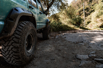 Dirty wheel of a jeep in a rural path