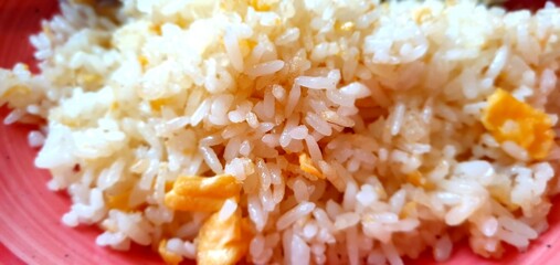 Fried rice with egg side dish close-up. Asian cuisine. Japanese food. Cooked rice in a plate dish.