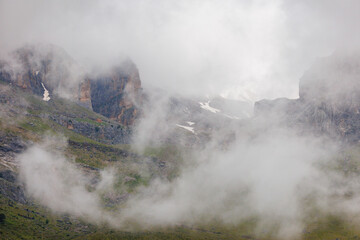 Mountains in the clouds. View of the mountain peak in the fog. Beautiful landscape with high cliffs. Dedegol. Turkey.