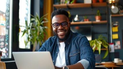 Naklejka premium Portrait Of A Successful Businessman Black Man At His Workplace In A Creative Agency Using A Laptop Reviewing Work Projects. Generative AI