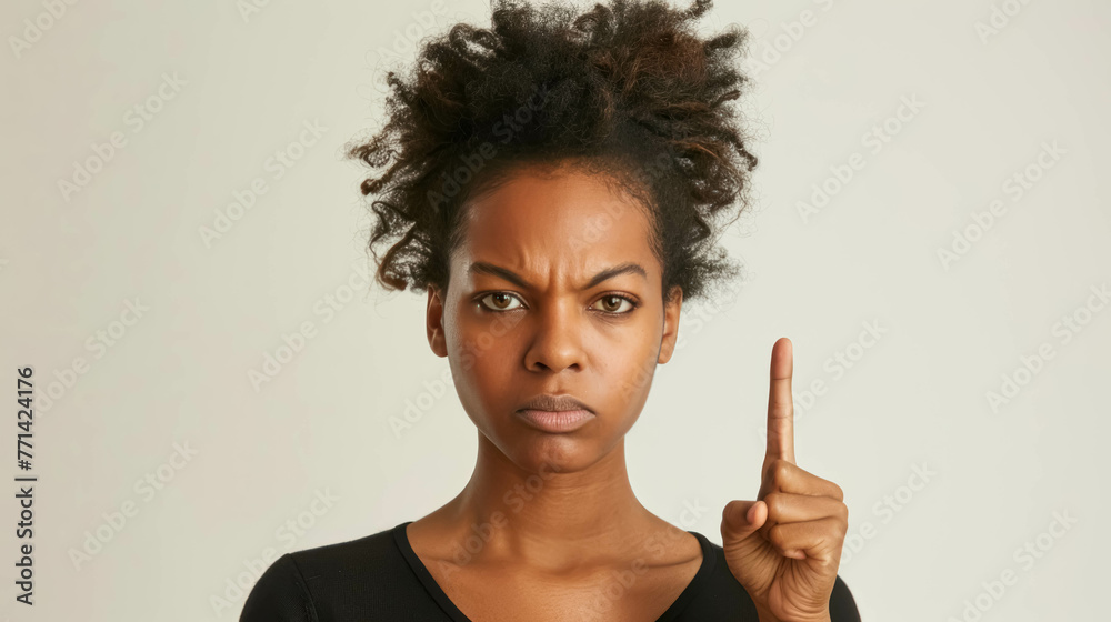 Wall mural Angry Black Woman Making A Disapproving Gesture With Her Finger. Conveying a Sense of Disagreement or Refusal