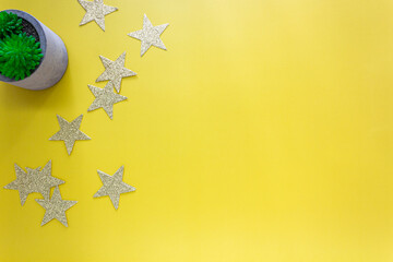 Celebration background with glitering stars lay on bright yellow background