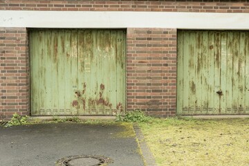 rusty green garage doors in the rain