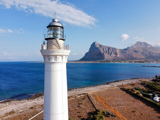 the coast of San Vito Lo Capo with the white lighthouse tower in the foreground