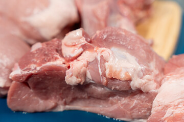 Pork meat cut into pieces lies on a cutting board. Pork meat close-up.