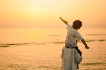 silhouette, sky, sand, sunlight, sea, beach, health, freedom, sunrise, sunshine. A young boy is...