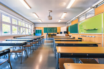 empty classroom with tables and chairs.