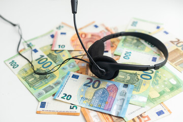 euro banknotes headphones headset. Money and technology still life concept. - obrazy, fototapety, plakaty