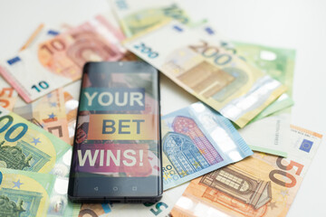 betting on sports, smart phone with working online betting mobile application