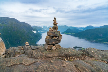 A cairn stack of stones and view from hiking Rampestreken and Nesaksla in Andalsnes - 771449723