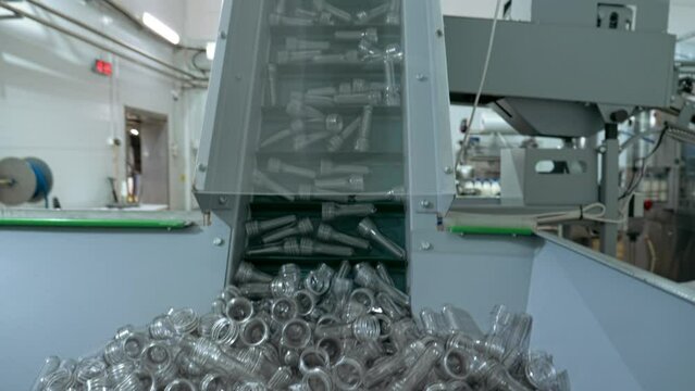 Dairy Food Factory. A lot of Non Recyclable Plastic Containers are used. Non Recyclable Cups are moving upwards on the Production Line. Multiple Non Recyclable Waste Items. Industrial Production.