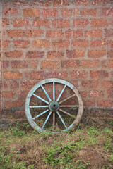 Fototapeta na wymiar A wooden wheel of a bullock cart just outside of beautiful House, Kokan, Maharashtra, India.
