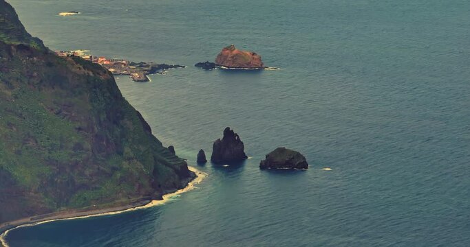 drone shot of the Ilheus da rib arch, on the coastline of Ribeira da Janela, foggy morning, in Madeira, Portugal
