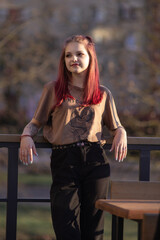 Portrait of a young red-haired girl outdoors in spring.