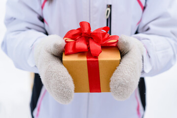 girl holds Christmas present in hands
