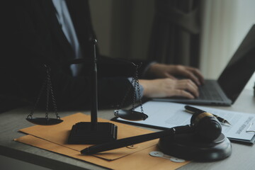 Business and lawyers discussing contract papers with brass scale on desk in office. Law, legal...