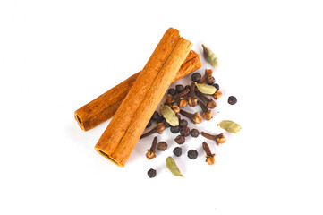 Cinnamon sticks, black pepper, spiced cloves and cardamom isolated on white