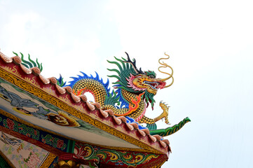 BANGKOK, THAILAND - MARCH 30, 2024: Closeup of Colorful Dragon Decoration with blue sky background at Chinese Temple, Thailand.