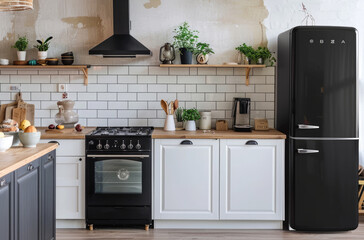 Black refrigerator, white cabinets and wooden countertop in a Scandinavian style kitchen with hanging shelves on the wall, natural light from the window