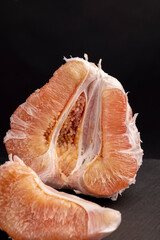 peeled red and pink pomelo on the table