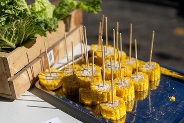 selective focus sliced ​​yellow corn Boiled and cooked on many skewers in a tray. Vendors guarantee the freshness and sweetness of the corn varieties for testing. For interest in corn seeds