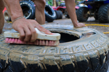selective focus Used car tires are being cleaned by employees at a used tire shop. Makes the tires look newer