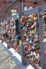 Obraz premium Love lock bridge at Katajanokka with bunch of locks. Couples putting locks on bridges. Bridge full of locks. Vertical photos.