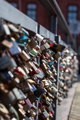 Obraz premium Love lock bridge at Katajanokka with bunch of locks. Couples putting locks on bridges. Bridge full of locks. Vertical photos.