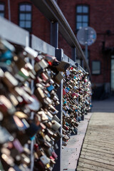 Obraz premium Love lock bridge at Katajanokka with bunch of locks. Couples putting locks on bridges. Bridge full of locks. Vertical photos.