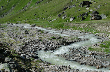 a mountain river flowing down a mountain gorge.a stormy water flow.