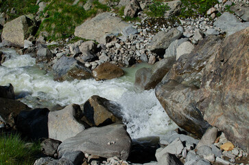 a mountain river flowing down a mountain gorge.a stormy water flow.