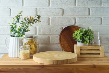 Empty wooden log  on kitchen table with food jars and plants over white brick wall  background.  Kitchen mock up for design and product display. - 771498592