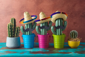 Mexican party concept with cactus and sombrero hat on wooden blue table over wall background. Cinco de Mayo holiday celebration - 771498714