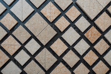 Symmetrical view looking down at diamond shaped granite tile floor
