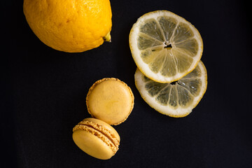 Traditional French sweets - lemon macaroons with cream lemon curd and lemon slices