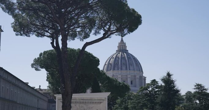 Establishing shot of the dome of famous landmark of Saint Peter's Basilica, the papal enclave Vatican that is within the city of Rome, Italy