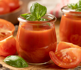 Tomato juice with basil leaves and sliced tomatoes - 771503947