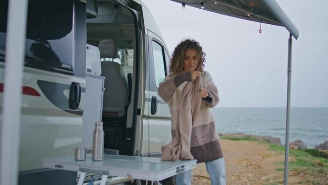 Calm traveller walking camping place wrapping in cozy scarf windy autumn day. 