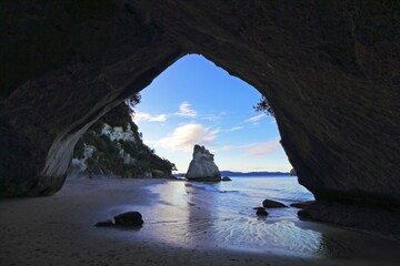 Tranquil scene of Cathedral Cove at dusk in New Zealand.