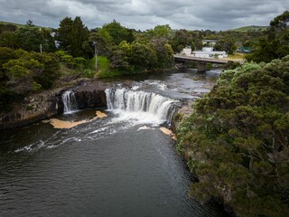 Fototapeta na wymiar Aerial shot of Haruru Falls surrounded by greenery in Northland, New Zealand