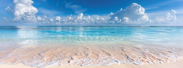 Beautiful sandy beach with white sand and rolling calm wave of turquoise ocean on Sunny day. White clouds in blue sky.  Maldives, perfect scenery landscape, copy space, panoramic view.