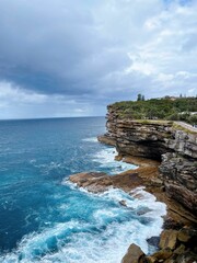 Tranquil seascape with a rocky shoreline with lush vegetation