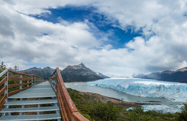 Scenic Wooden Walkway Leading to a Majestic Glacier