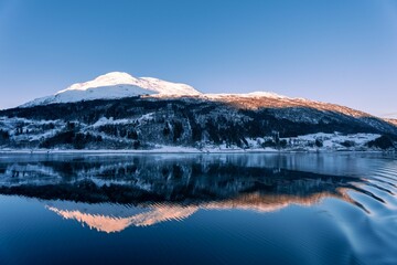 Idyllic scene of a tranquil mountain lake surrounded by a stunning blue sky in Haugesund, 
Norway