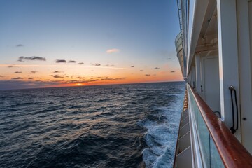 looking out over the ocean at sunset from the bow of a ship