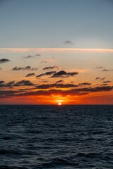 Picturesque orange sunset is illuminated over tranquil, blue waters