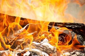 Burning pile of cardboard in a glowing fire.