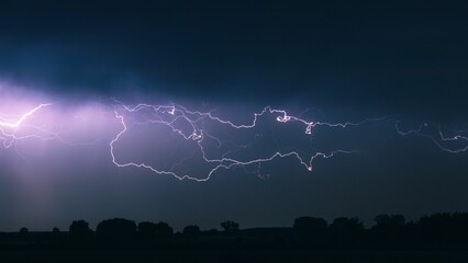 Naklejka na ściany i meble Stunning image of a lightning bolt illuminated in the purple night sky